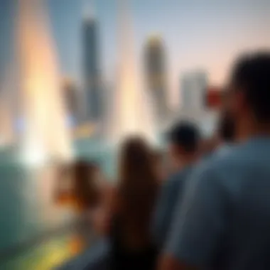 Visitors Experiencing the Fountain Show Visitors enjoying the fountain show with the Dubai skyline in the background